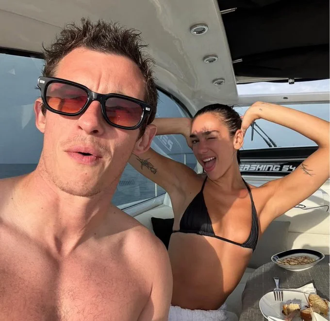 Dua Lipa & Callum Turner stun in new vacation photos.